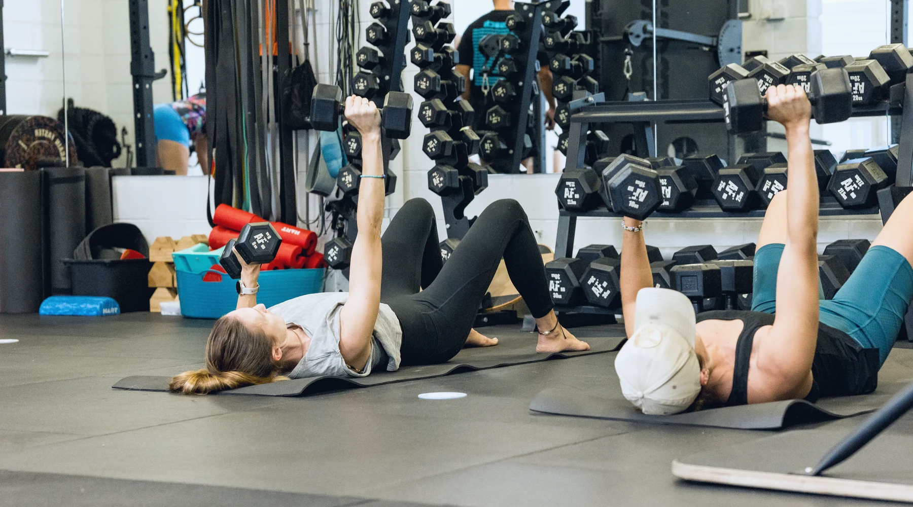 An adult student working from a bad position while a coach watches on at Ako Martial Arts